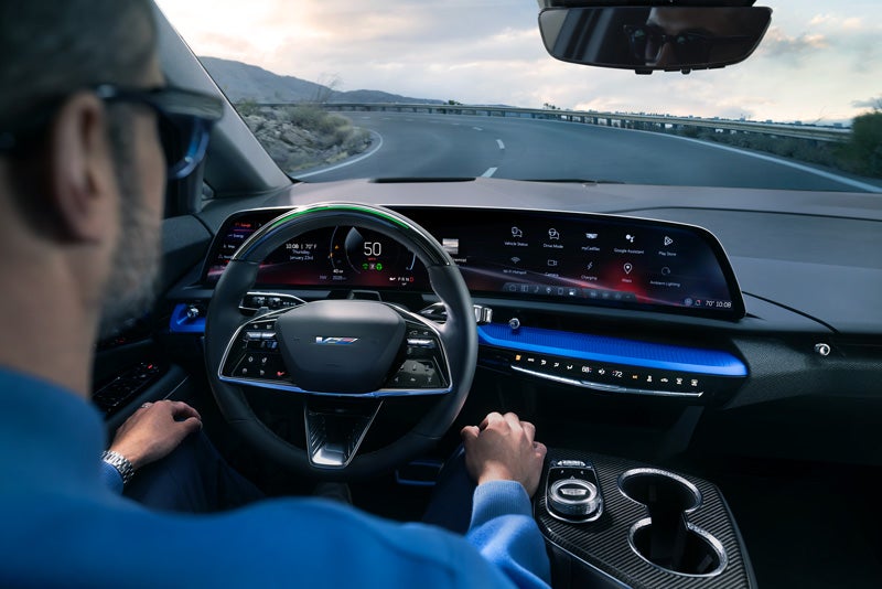 Front View of the 2026 OPTIQ-V Driving Through the Dusk Utilizing its Headlights | Bical Cadillac in Brooklyn NY